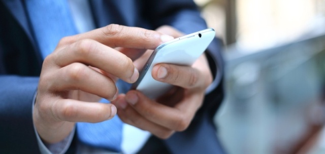 Close up of a man using mobile smart phone